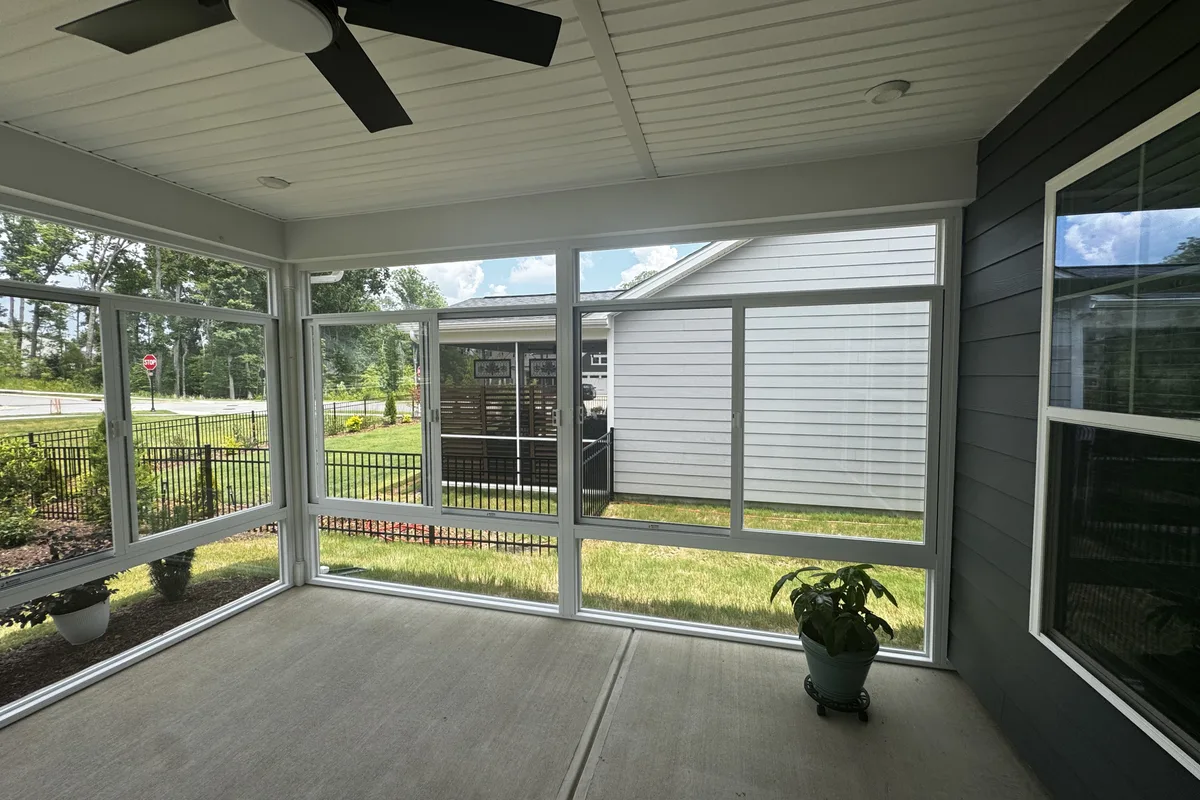 Exterior angle view of the completed Mantle Ridge 3-season glass enclosure showing how it complements the home and yard in Indian Trail NC