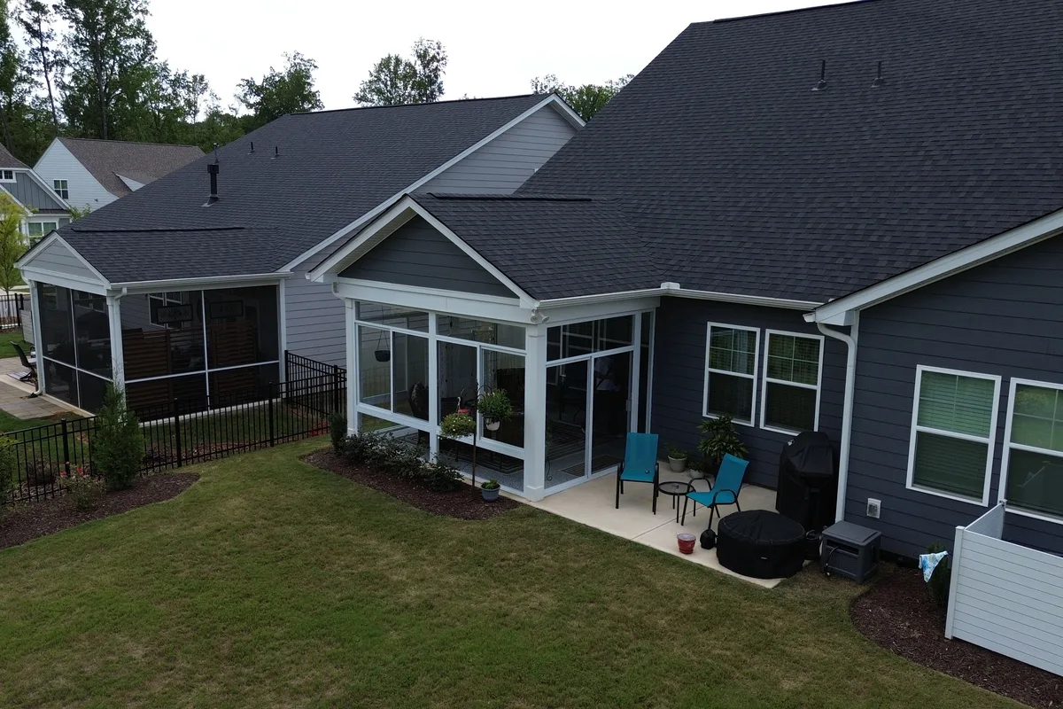 Close view of horizontal sliding glass windows installed on the Mantle Ridge enclosure in Indian Trail NC with white mullion framing