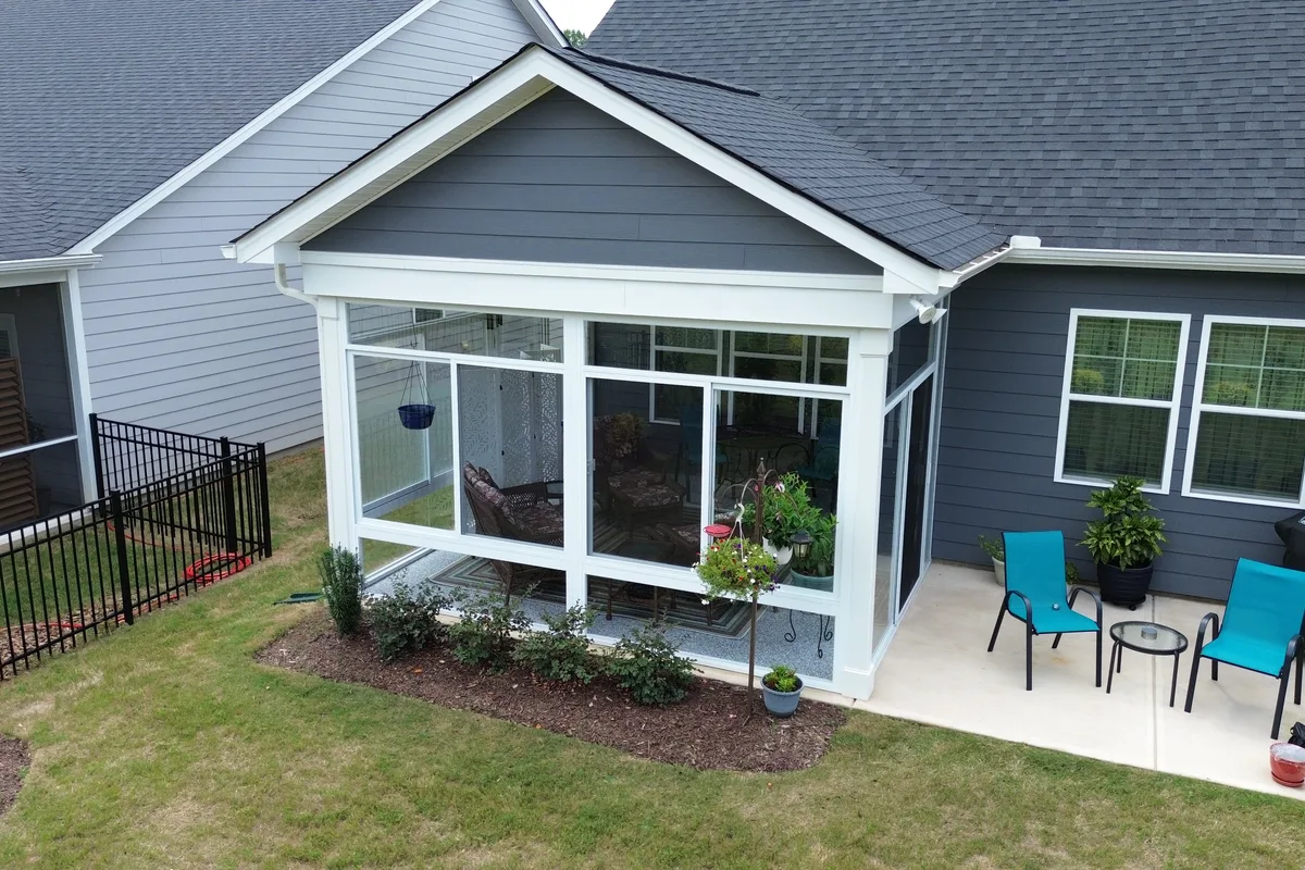 Wall expander and white aluminum frame detail where the new Mantle Ridge glass enclosure meets the existing home structure in Indian Trail NC