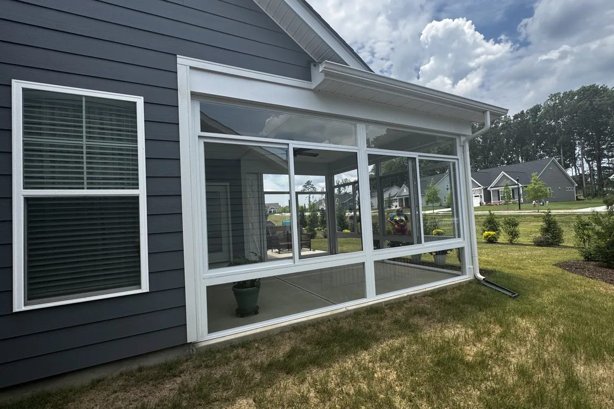 Roofline integration detail showing how the Mantle Ridge glass enclosure connects cleanly to the existing porch roof in Indian Trail NC