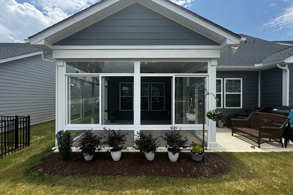 Completed Seravue 3-season glass enclosure on a Mantle Ridge home in Indian Trail NC showing white aluminum framing and sliding glass panels