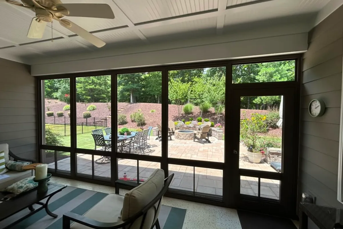 4-track stacking vinyl-film window panels open for ventilation on Gaston County porch