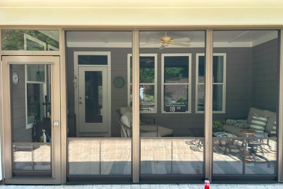 Fiberglass screen backing visible behind raised vinyl-film panels on Belmont NC porch