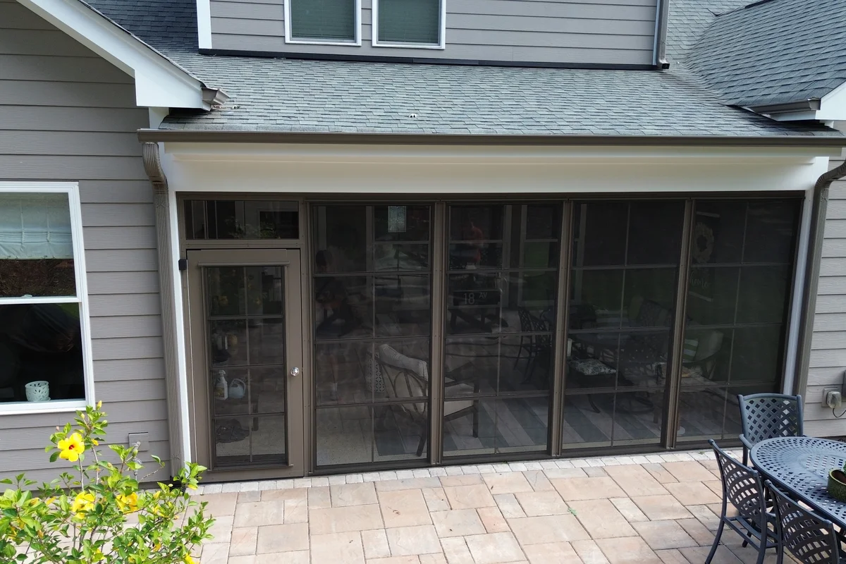 Completed 3-season vinyl-film porch enclosure with Earthstone aluminum framing on a Belmont NC home