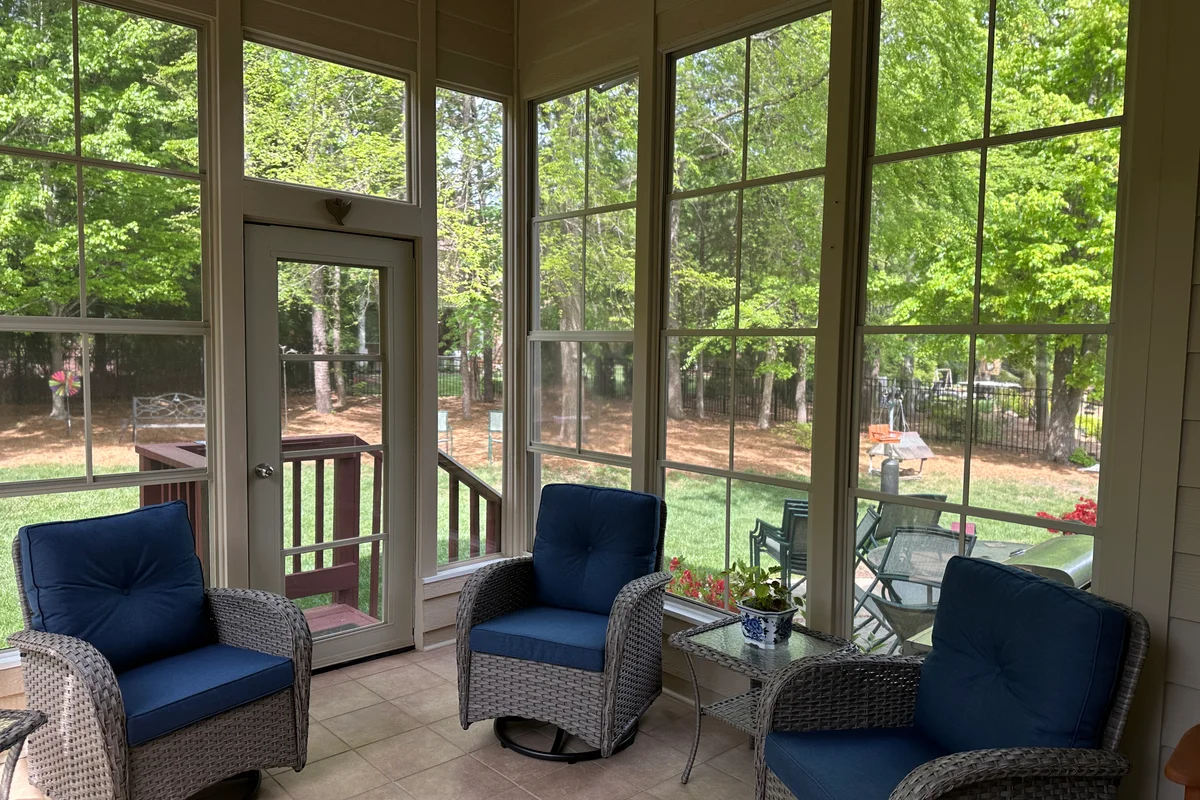 Finished vinyl film porch enclosure exterior view Camrose Matthews NC