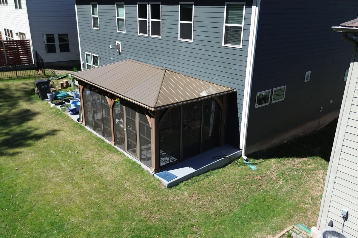 Craft-Bilt vinyl film stacking window panels fully closed on Clems Branch Charlotte NC enclosure showing clear view to backyard