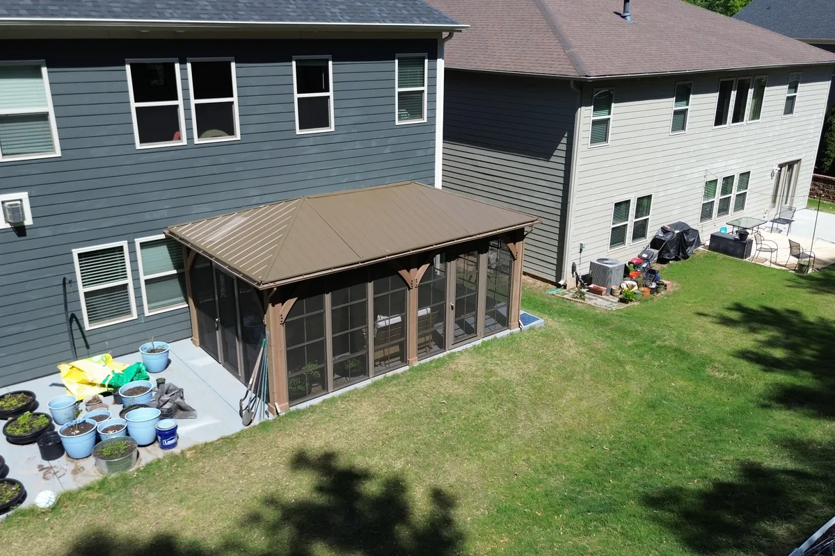 Vinyl film stacking window panels stacked open on Clems Branch pergola enclosure showing full airflow position in Charlotte NC