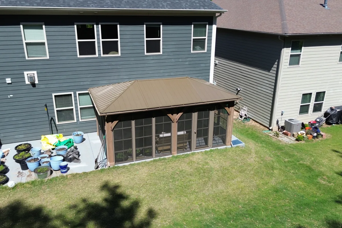 Custom aluminum filler piece at top of Craft-Bilt window frame on Clems Branch prefab pergola enclosure Charlotte NC ensuring clean fit