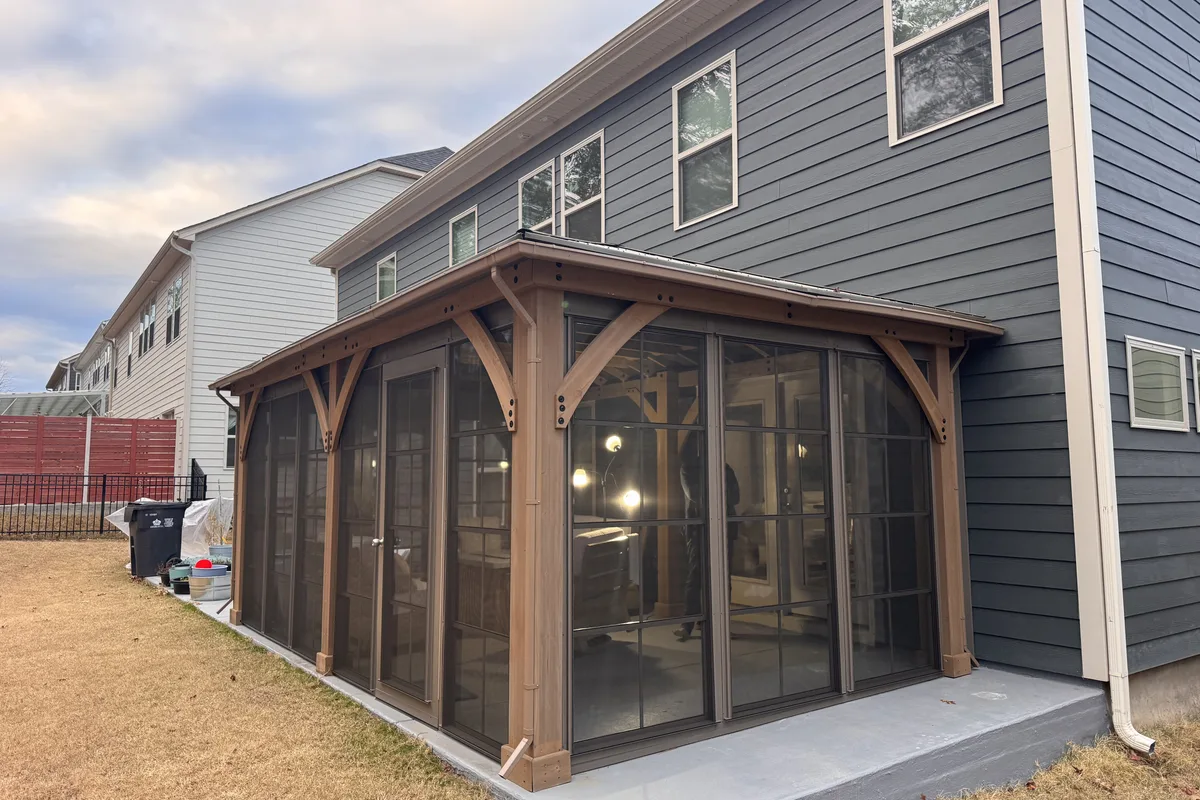 Craft-Bilt vinyl film stacking door installed on Clems Branch Charlotte NC pergola enclosure with matching aluminum frame detail