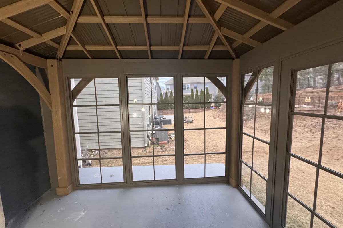 Interior view of Clems Branch Charlotte NC 3-season vinyl film enclosure showing plant protection space and usable room year round