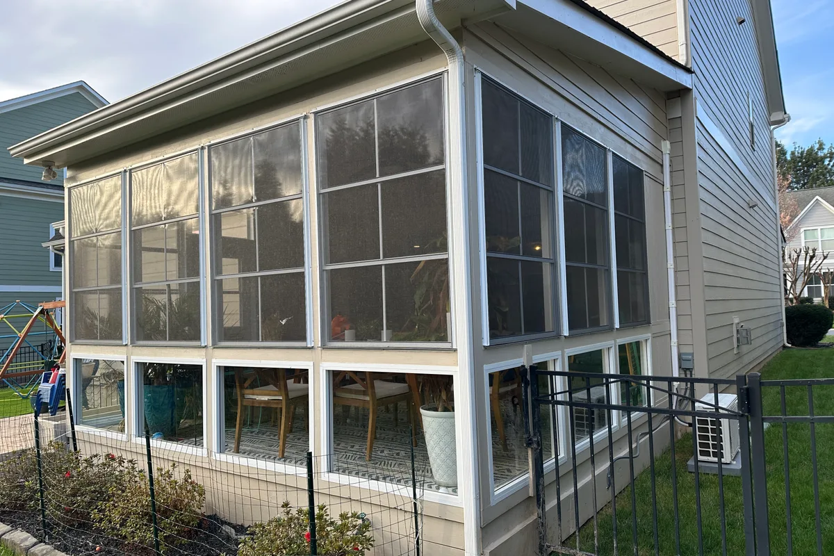 Interior quarter round trim finishing detail on completed vinyl film porch enclosure Indian Land SC