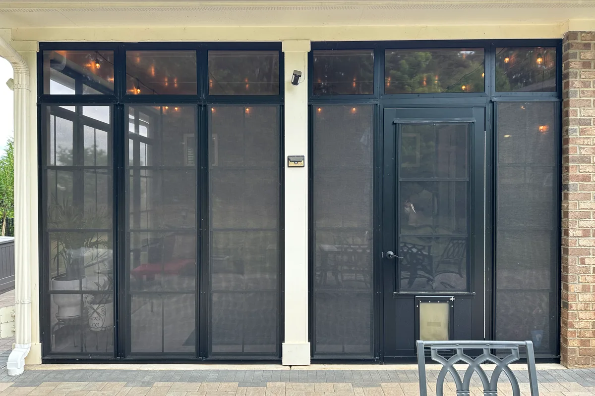 Craft-Bilt vinyl film stacking windows installed on Livery Stable porch showing stacked-open position for ventilation
