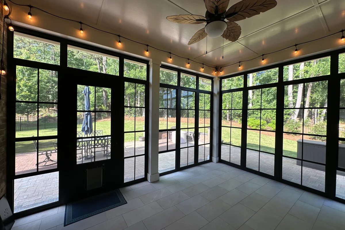 Full interior view of Livery Stable Matthews NC 3-season vinyl film porch enclosure with tile floor and natural light