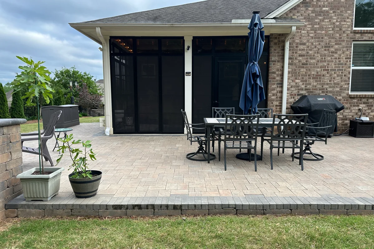 Exterior view of Livery Stable Matthews NC home with completed vinyl film 3-season porch enclosure and tile flooring visible