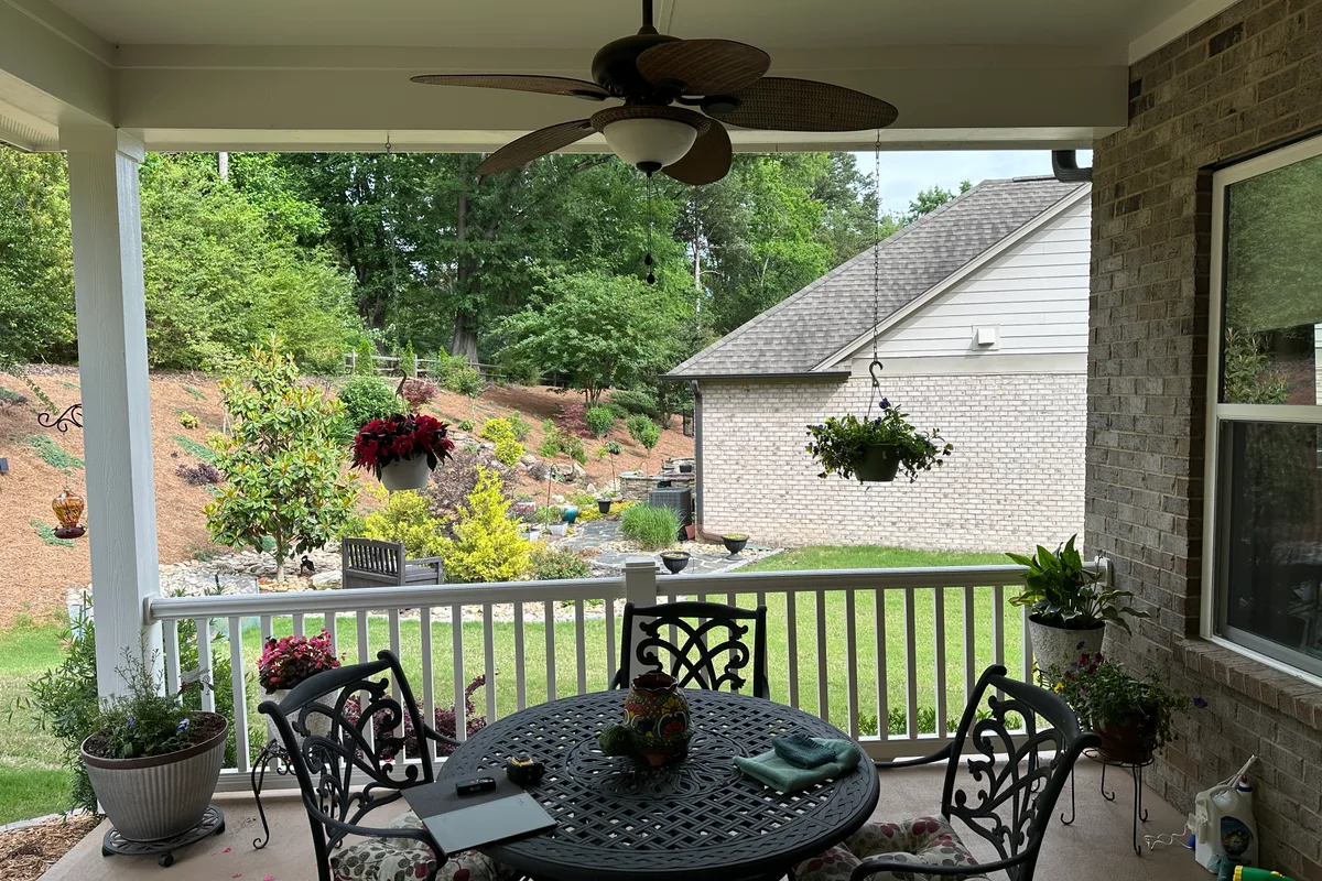 Uncovered porch area prior to 3-season room enclosure project Matthews NC