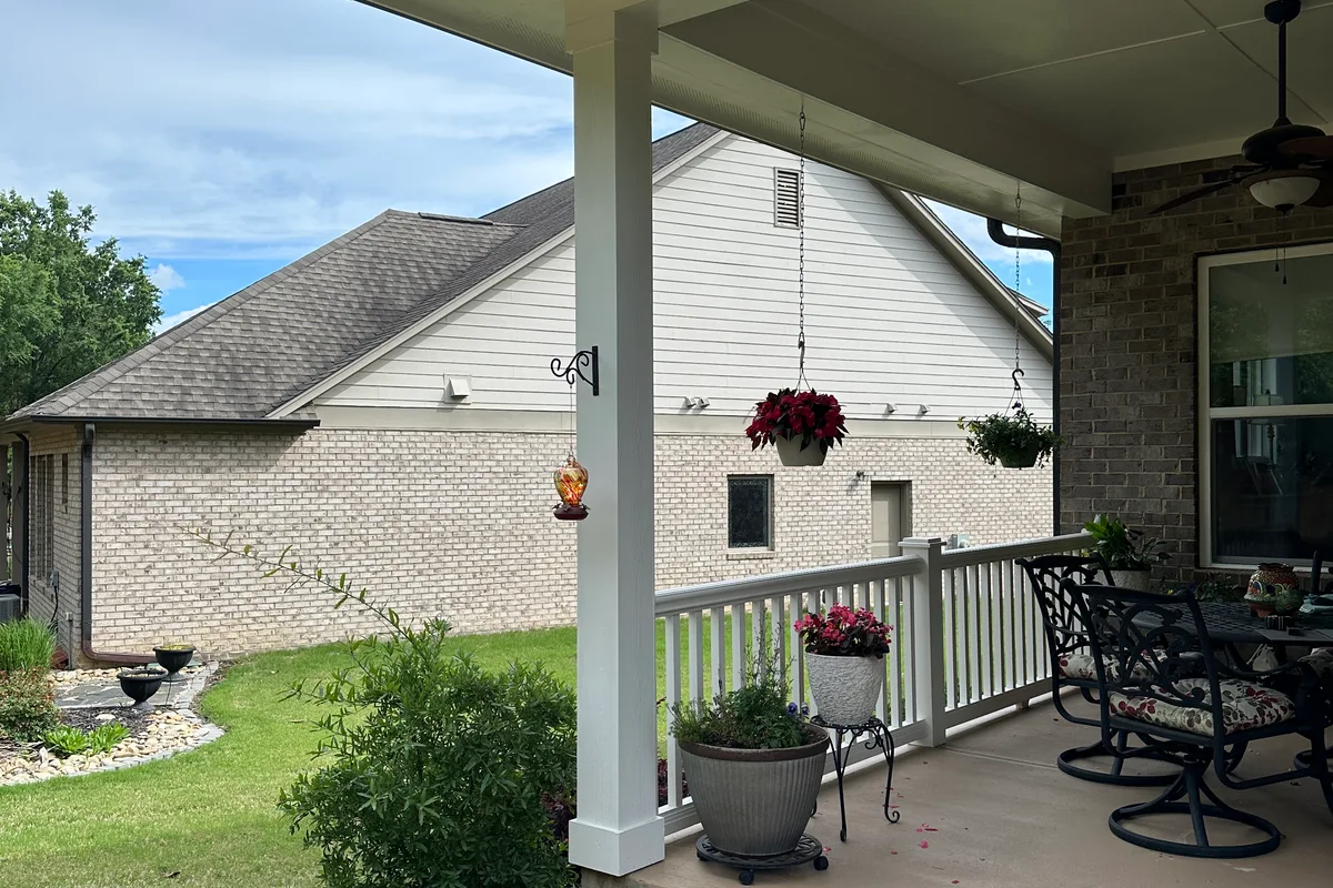 Open patio frame before 3-season vinyl film room addition