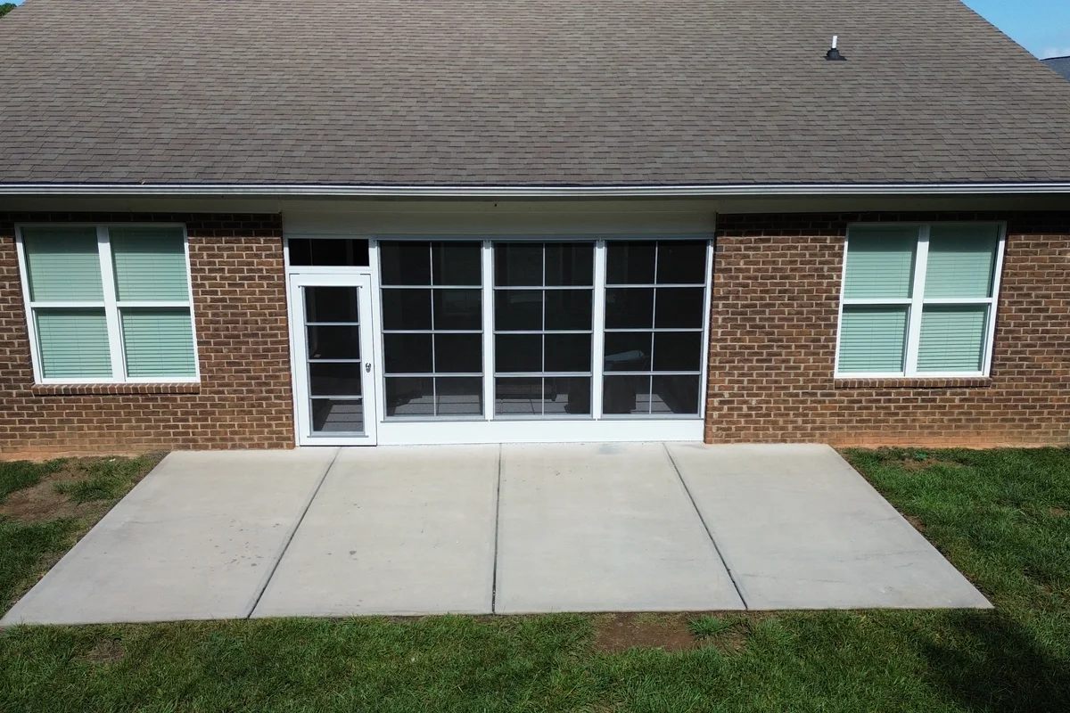 After: completed 3-season vinyl-film porch enclosure exterior in Mullis Forest, Mint Hill NC