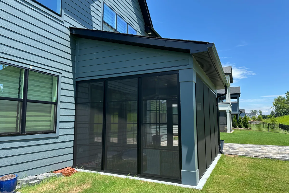 Black aluminum wall system framing Craft-Bilt stacking windows on Tega Cay porch
