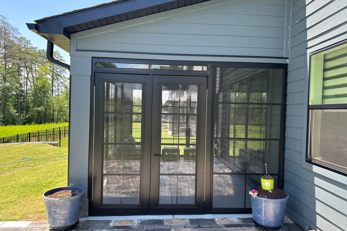 Corner framing detail of 3-season porch enclosure in Tega Cay SC showing aluminum joinery