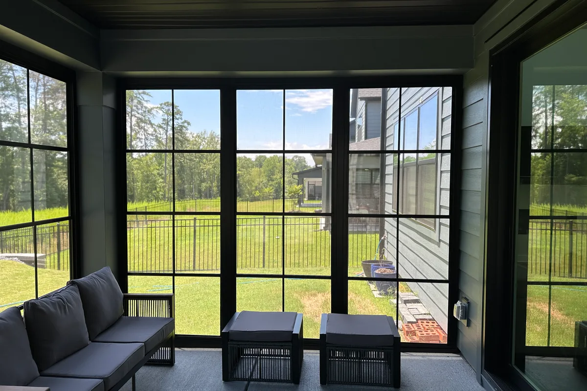 Interior view of Tega Cay vinyl film enclosure with panels closed showing protected porch space