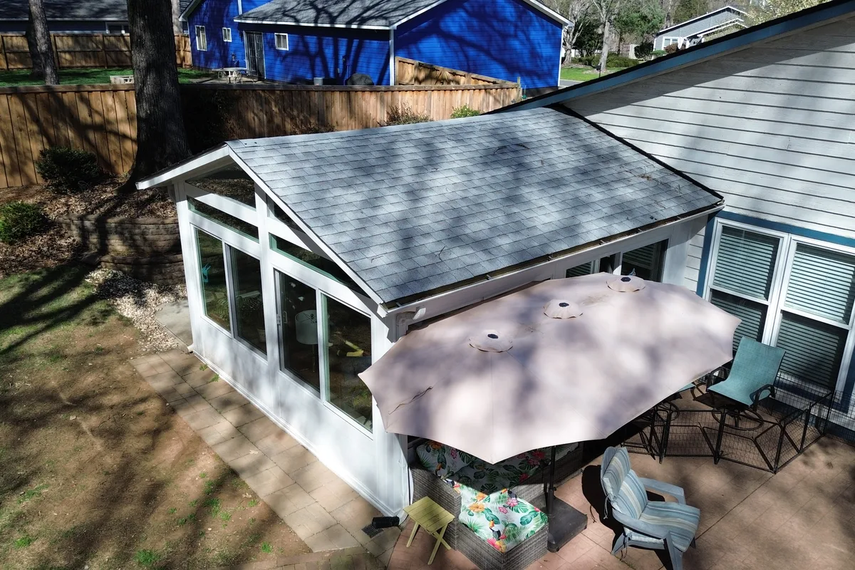 Exterior view of finished 4-season enclosure addition on Rainbow Forest home with new roof